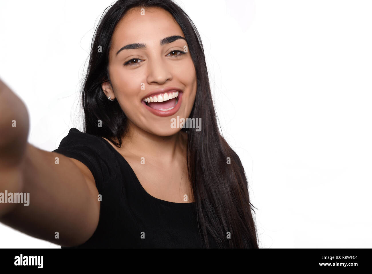 Close-up of young beautiful woman taking selfie. Isolated white background Stock Photo