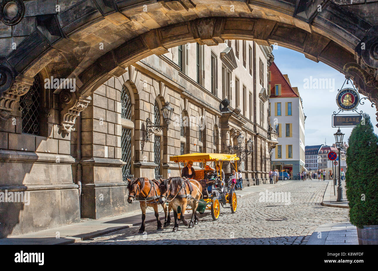 Germany, Saxony, Dresden, Taschenberg, a horse-drawn carriage passes under the connection bridge betwen Dresden Castle and Taschenbergpalais Stock Photo
