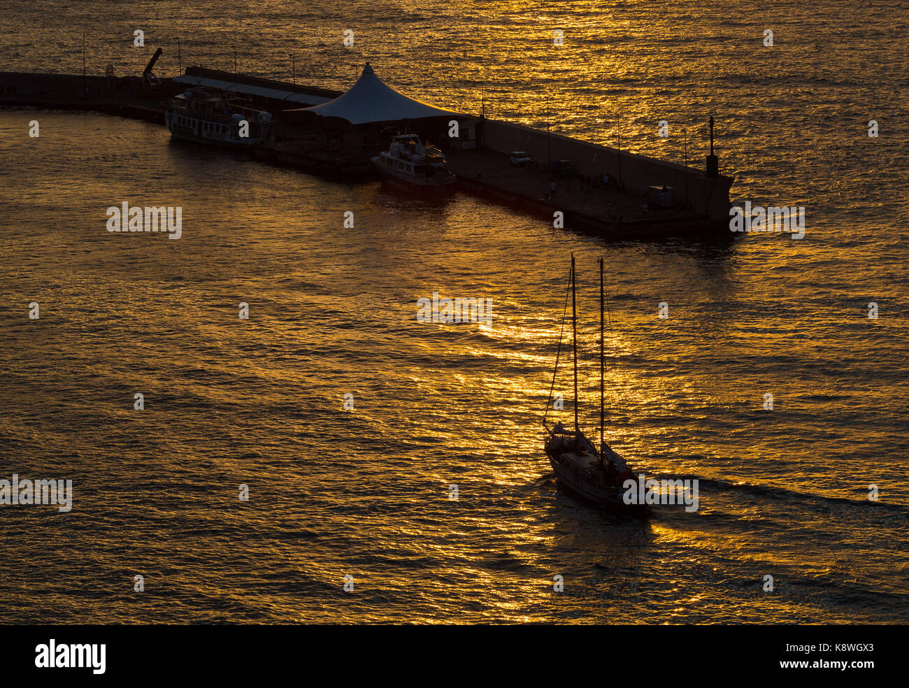 Sorrento, Italy, September 20 2017. A boat enters Marina Piccolo at sunset in Sorrento, Italy. © Paul Davey Stock Photo