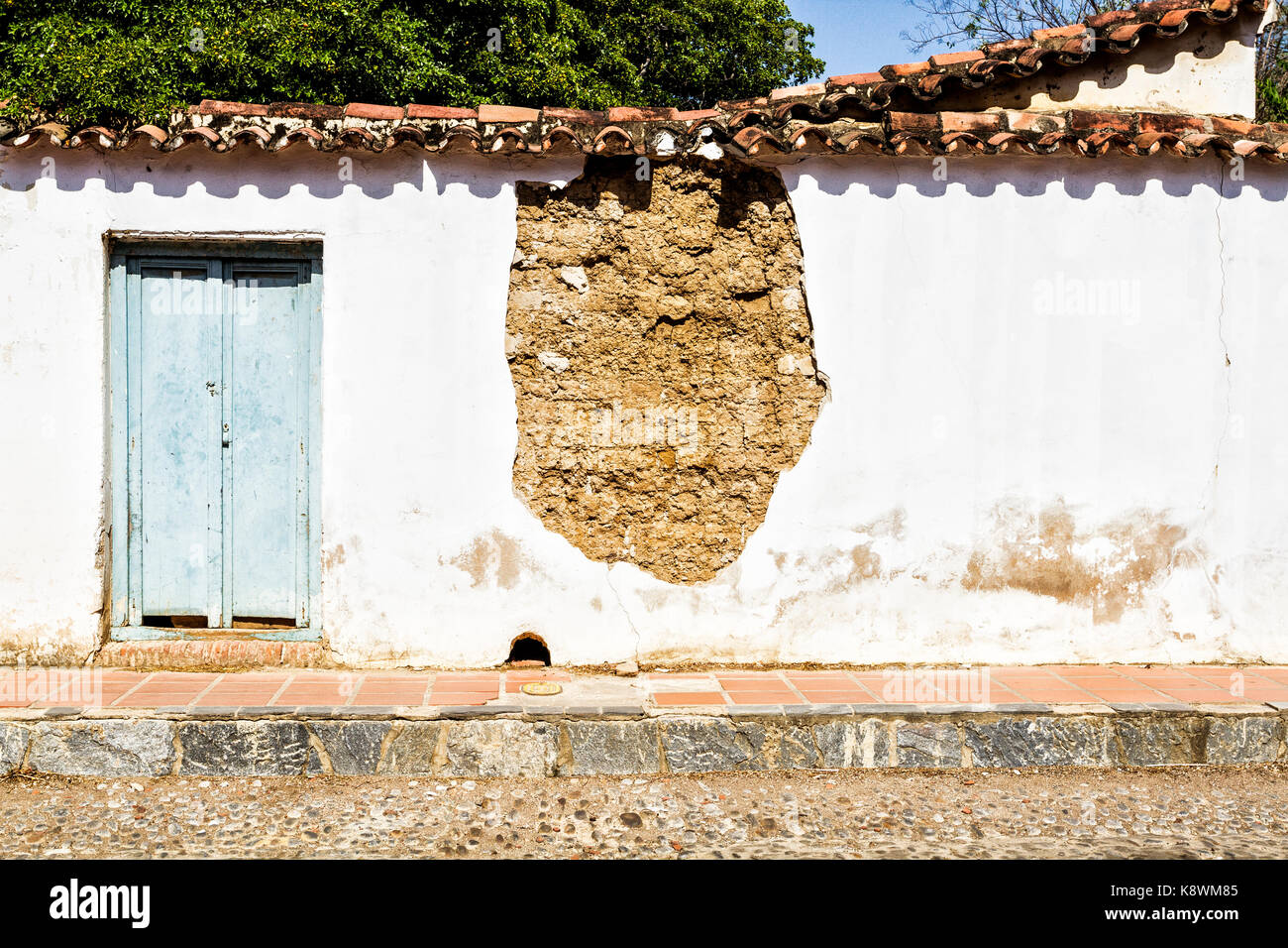 Front of a damaged colonial architecture house in historic center. Coro, Falcon state, Venezuela. Stock Photo