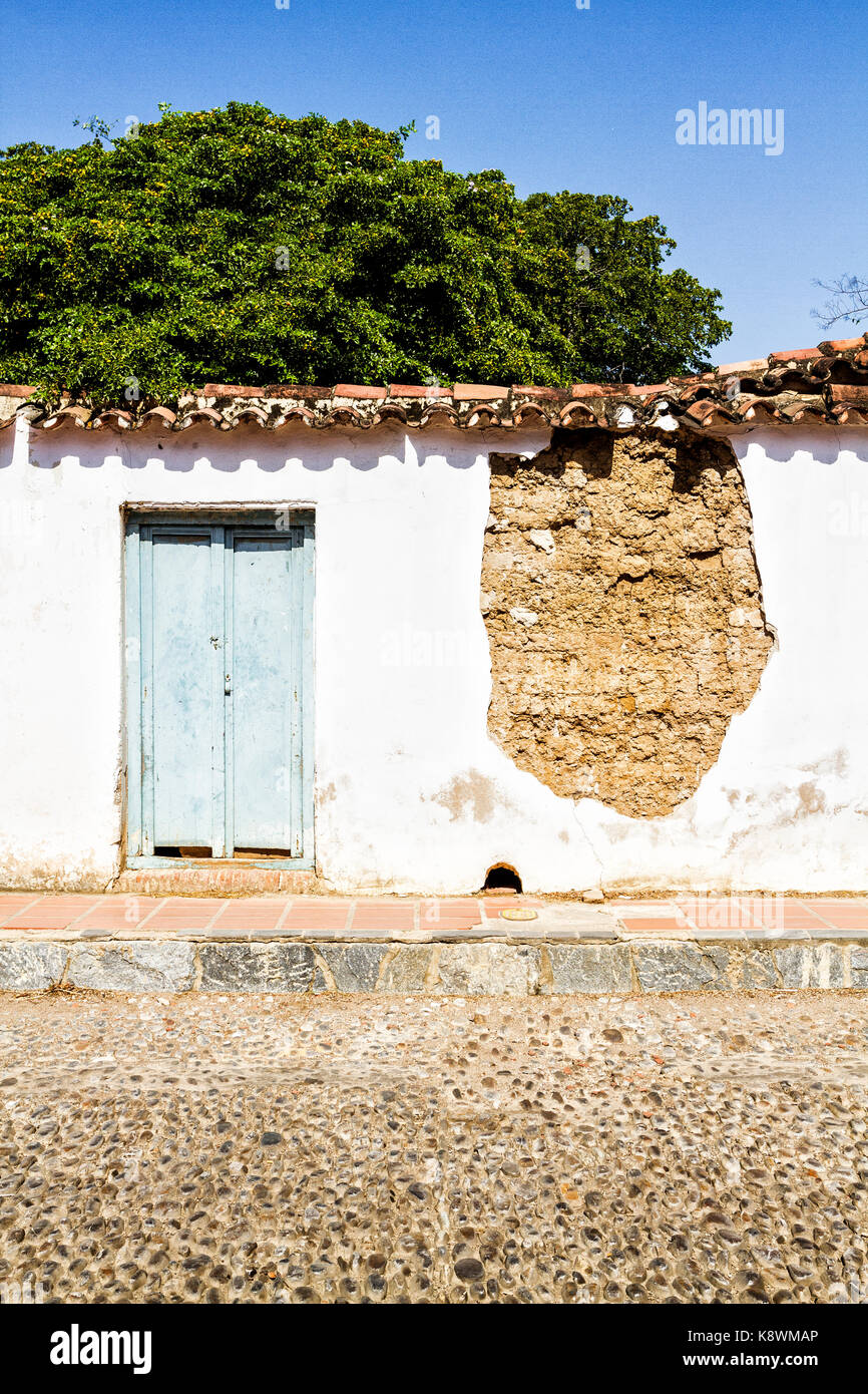 Front of a damaged colonial architecture house in historic center. Coro, Falcon state, Venezuela. Stock Photo