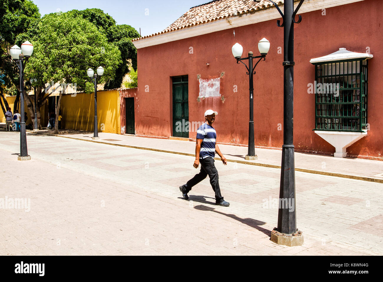 Pedestrian walking on the street in historic center. Coro, Falcon state, Venezuela. Stock Photo