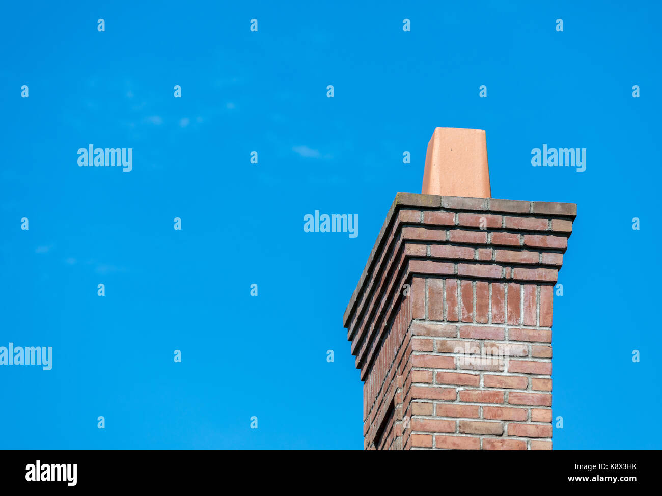 brick chimney against a blue sky Stock Photo - Alamy