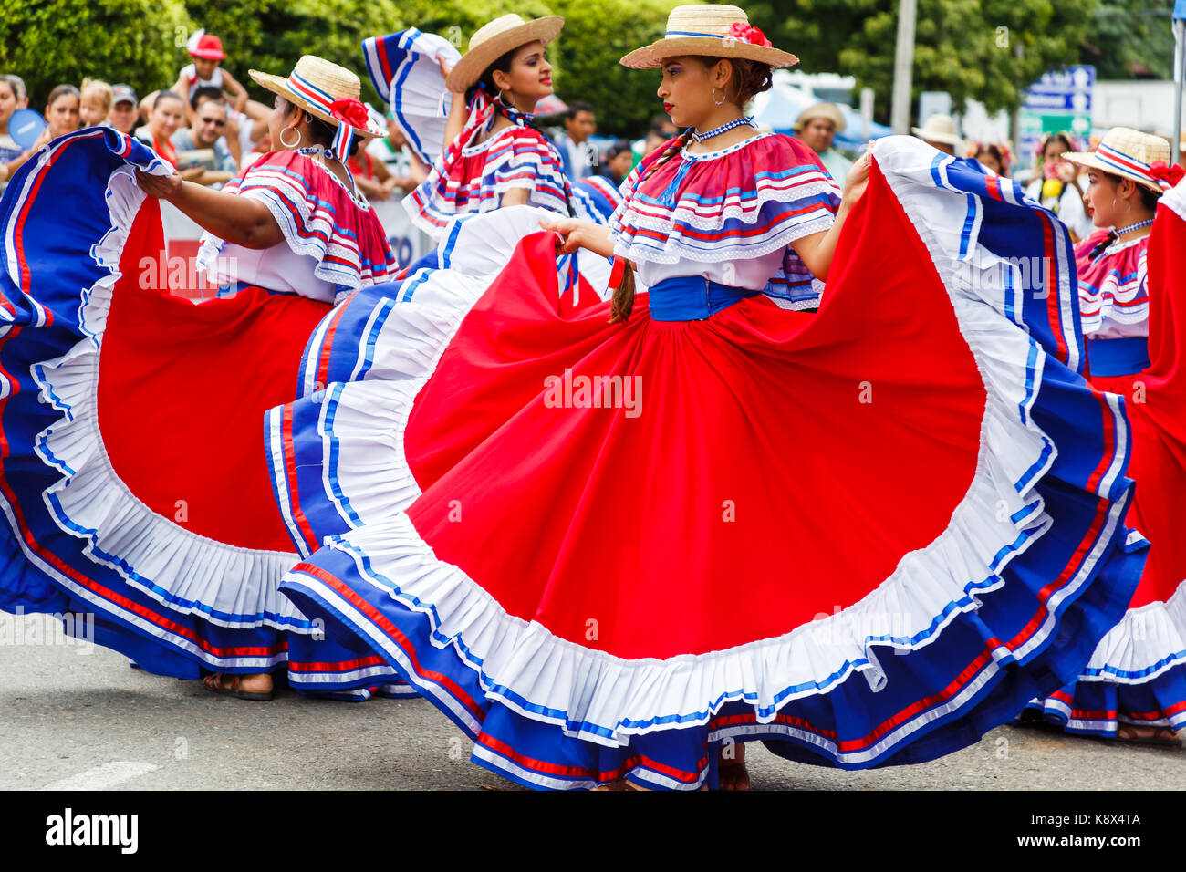 Dancers in colorful traditional costumes wow onlookers with their traditional dances during the Independence Day parade in Quepos, Costa Rica. Stock Photo