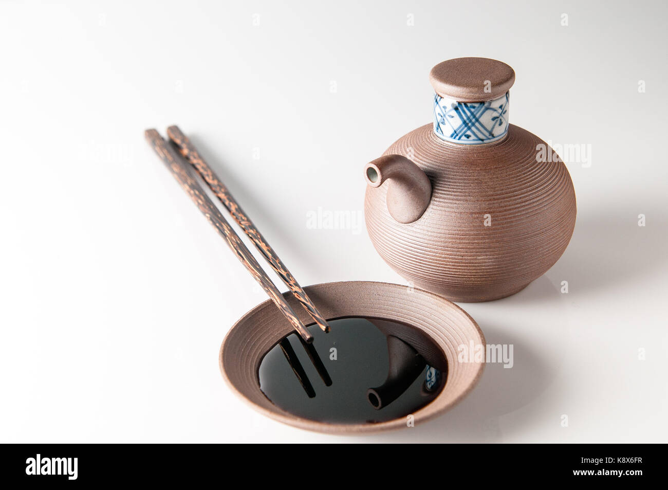 Ceramic jug & saucer for holding / dipping soy sauce. With chop sticks. From Japan. Stock Photo