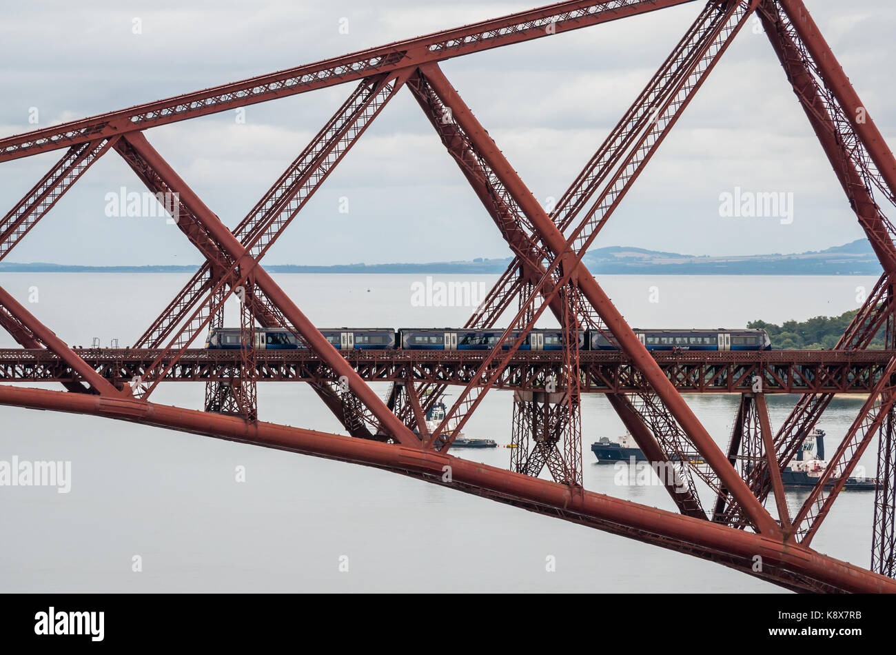 ScotRail train on cantilever Forth Rail Bridge over Firth of Forth, Scotland, UK Stock Photo