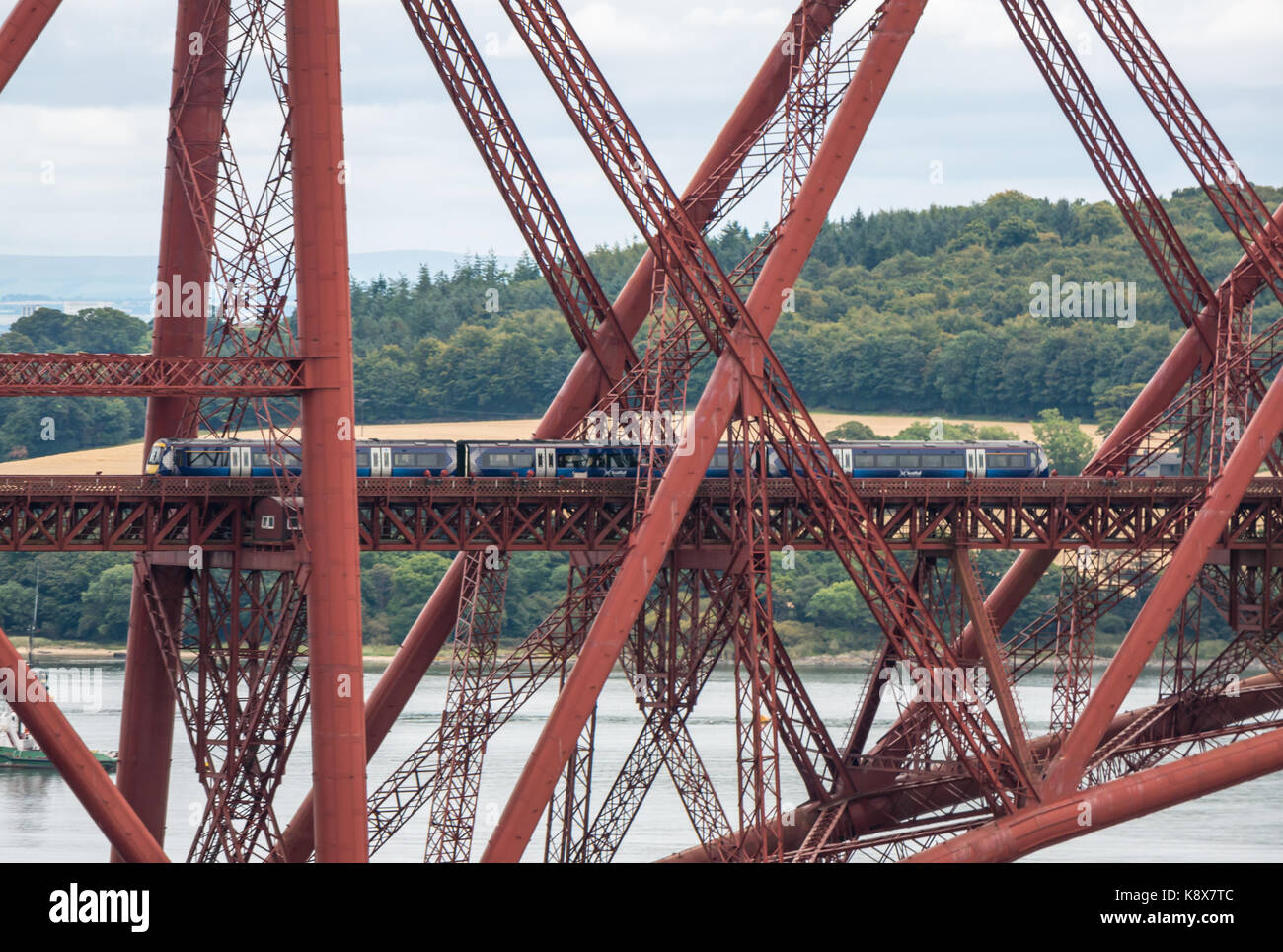 ScotRail train on cantilever Forth Rail Bridge over Firth of Forth, Scotland, UK Stock Photo