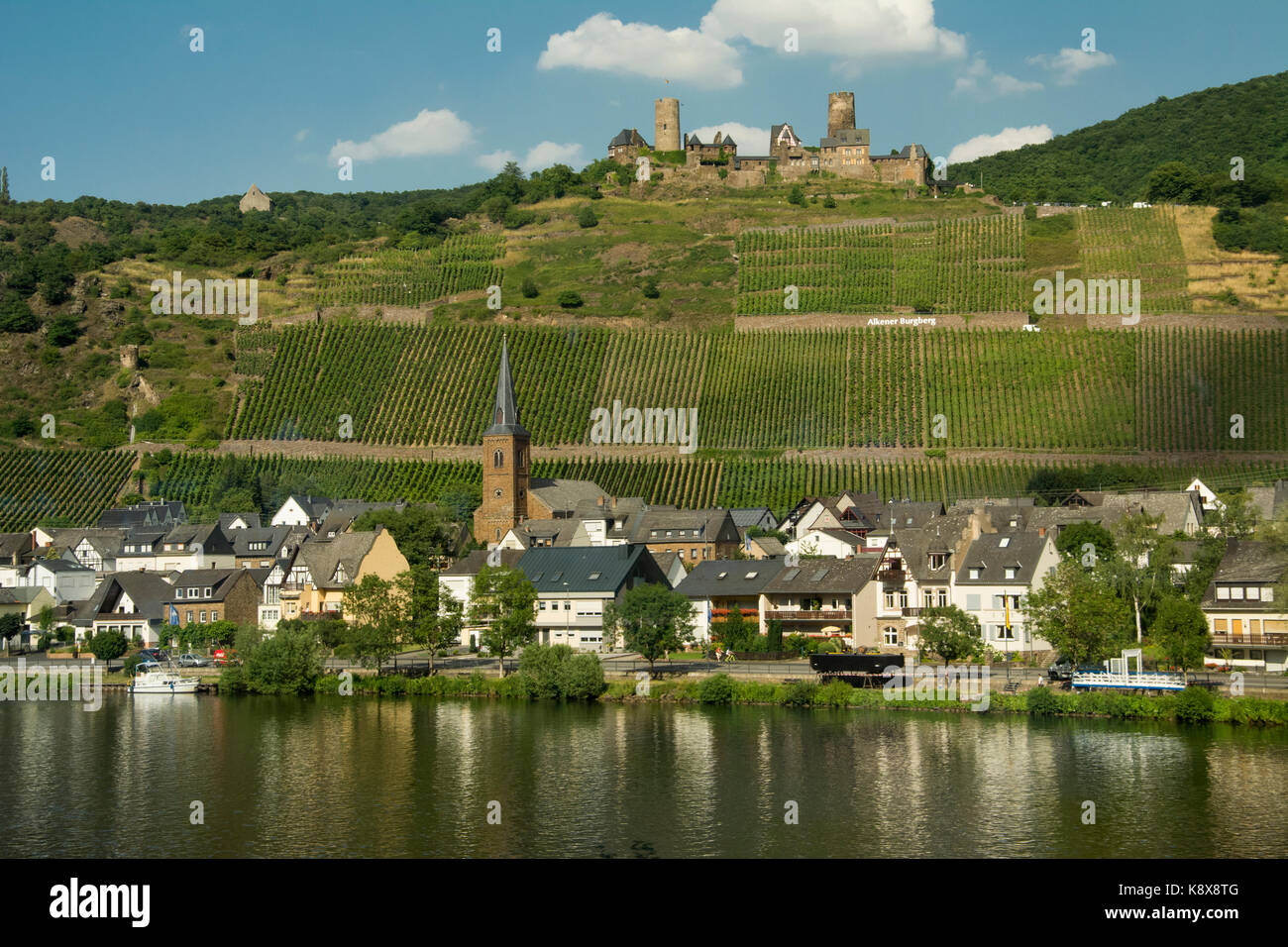 A Moselle Valley village and castle presents a bucolic scene, Rhineland-Palatinate, Germany Stock Photo