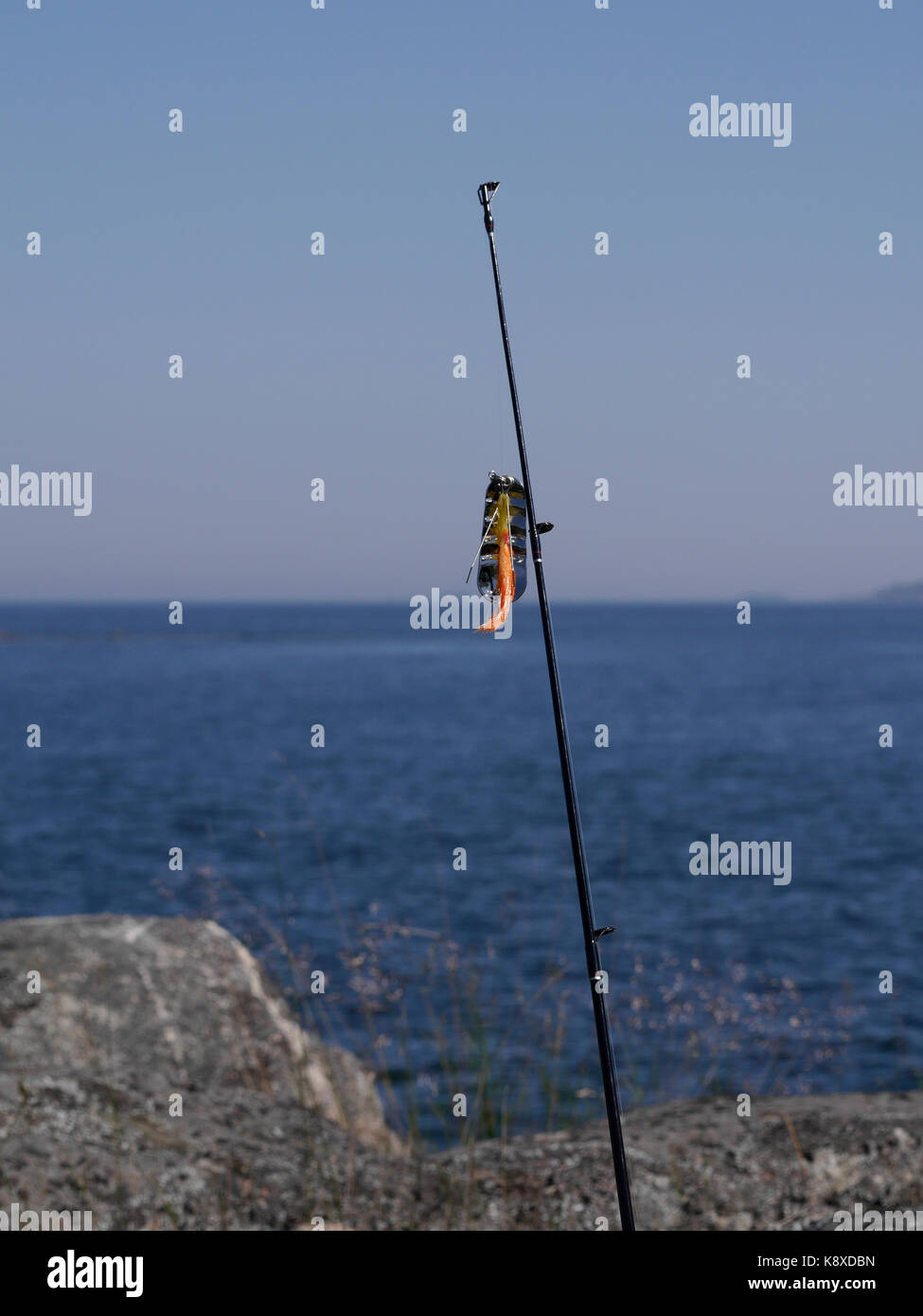 Fishing rod with lure, outside of Räfsnäs, Close to Gräddö, Rådmansö in the Roslagen archipelago North of Stockholm, Sweden. Stock Photo