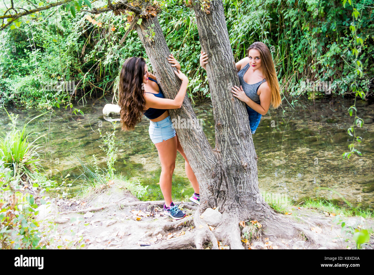 Two beautiful women in nature on the bank of a mountain river Stock ...