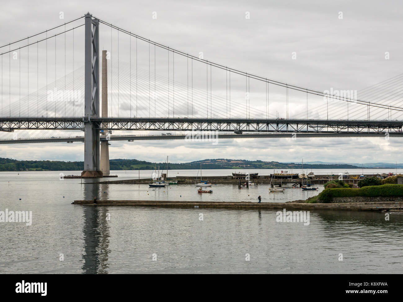 View of Forth Road Bridge and new Queensferry Crossing from North Queensferry with North Queensferry harbour, Fife, Scotland, UK Stock Photo