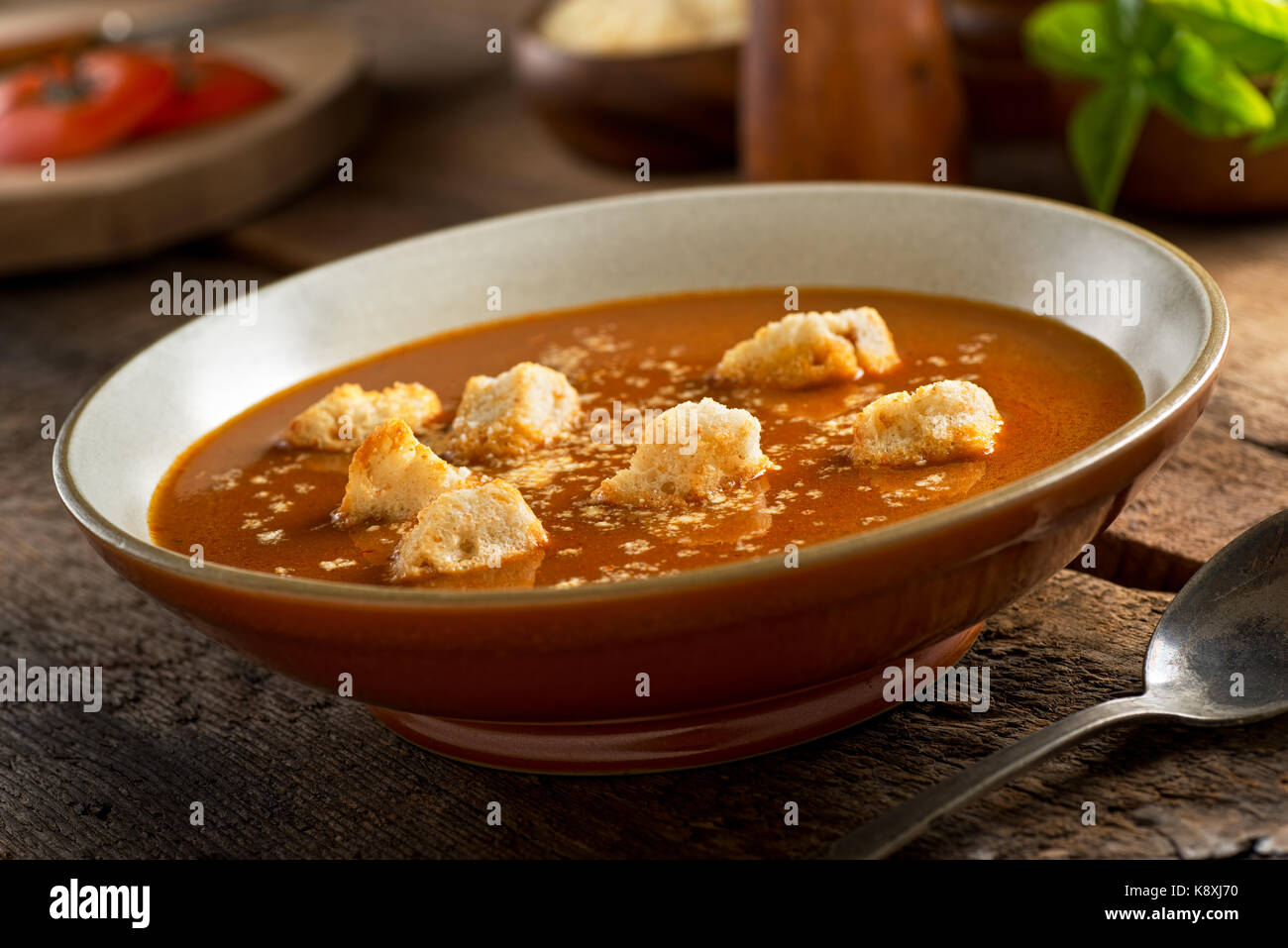 A delicious bowl of homemade rustic tomato soup with croutons and parmesan cheese. Stock Photo
