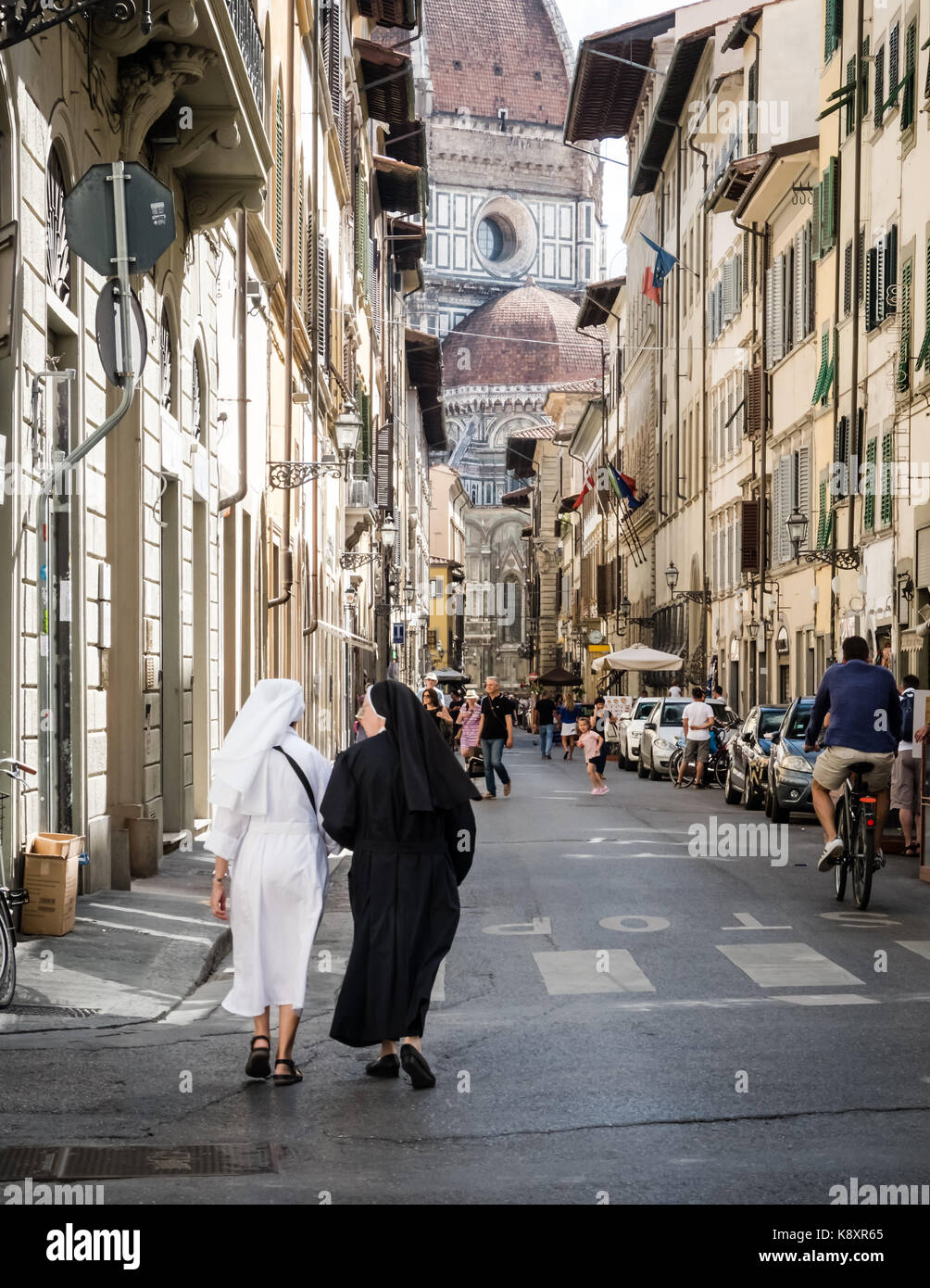 Nuns walking down Florence street toward the Duomo. Stock Photo