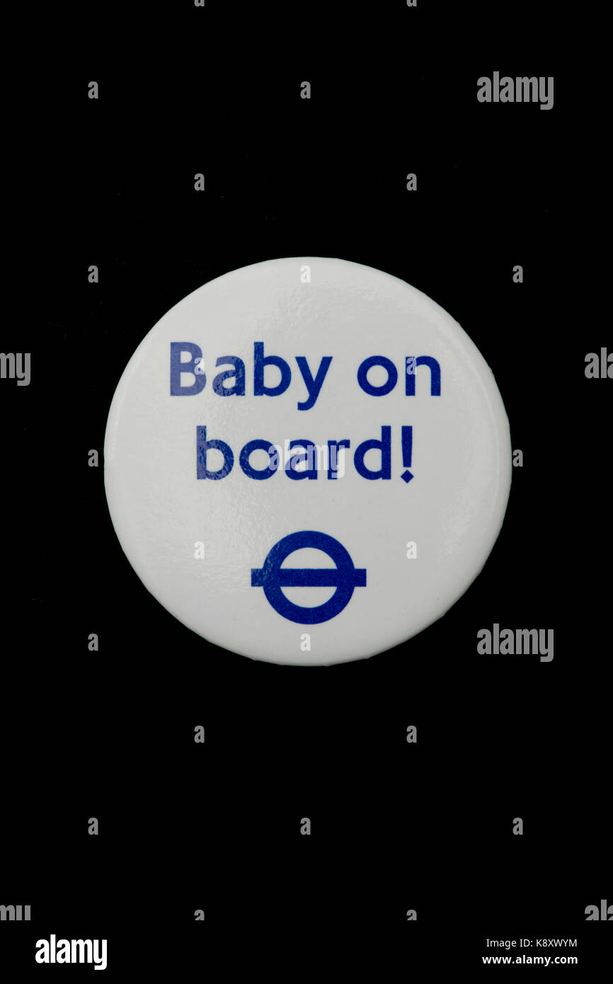 A London Underground Baby on Board badge worn on a black fabric garment (Editorial use only). Stock Photo