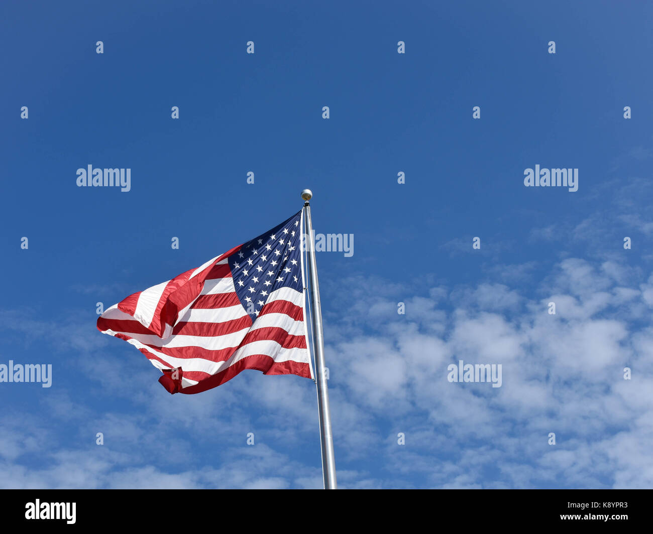 Flying American Flag with clouds and blue sky background Stock Photo ...
