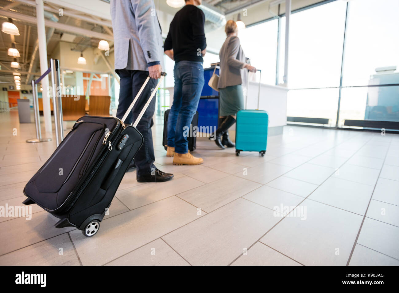 Passengers Standing On Floor With Baggage At Airport Reception A Stock Photo
