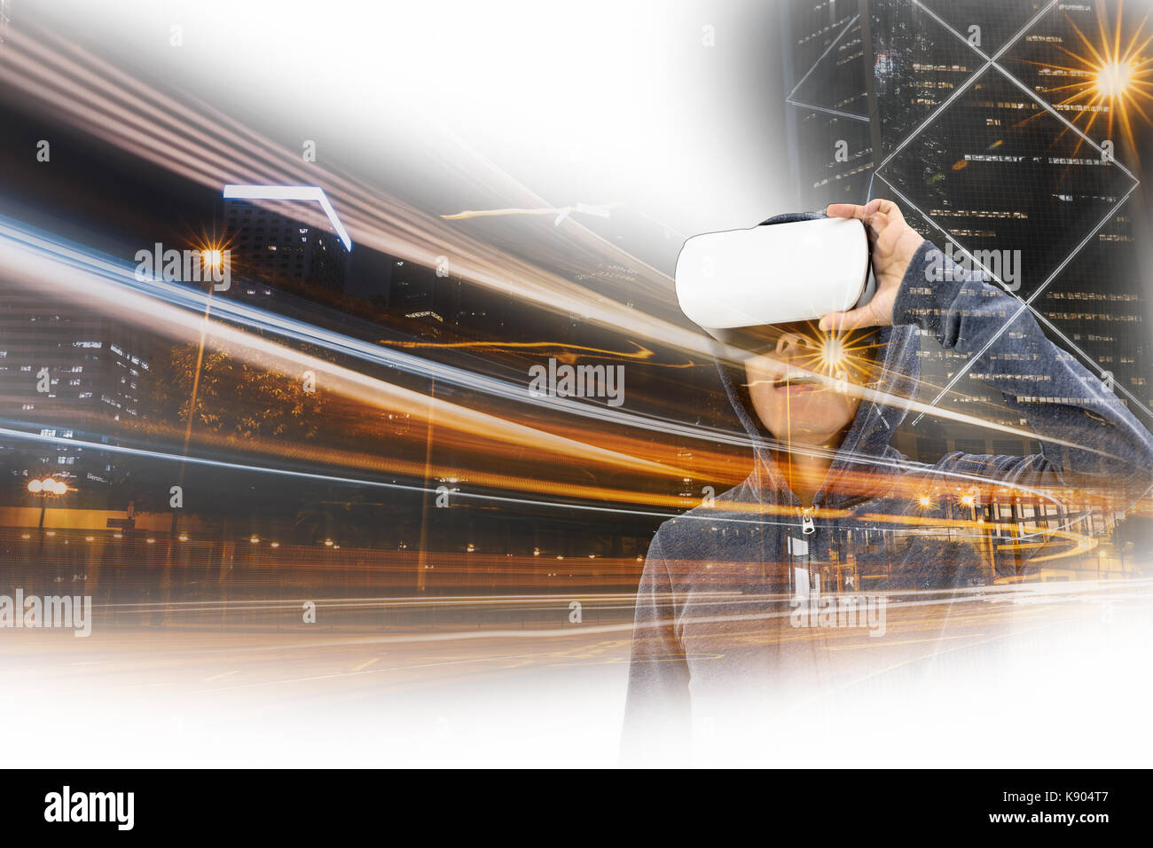 Double exposure of Asian man wearing VR over the Hong Kong Cityscape ...