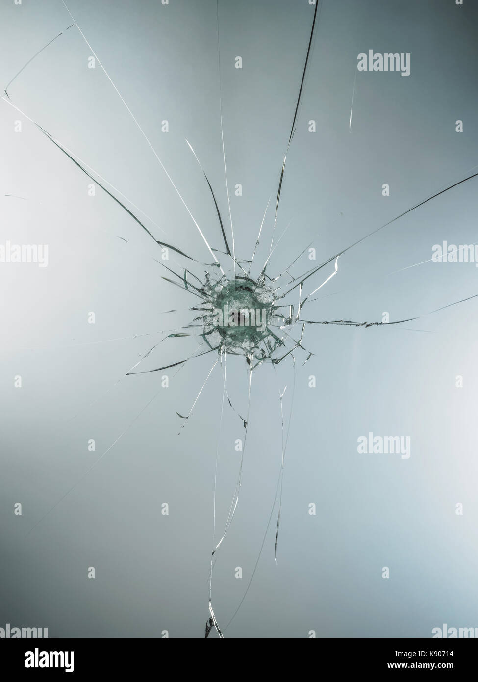 broken cracked glass with hole over white background Stock Photo