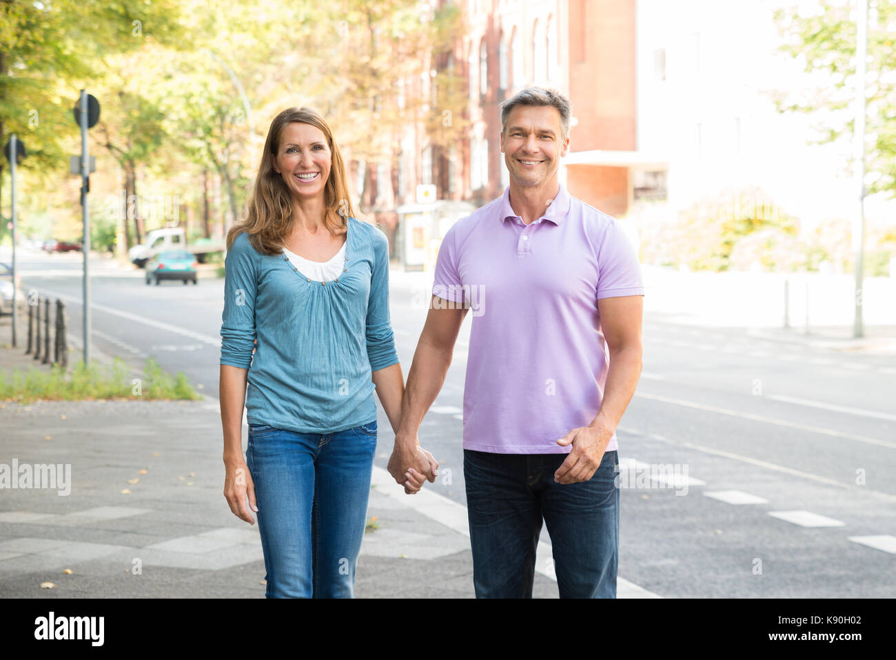 Mature woman walking on street hi-res stock photography and images - Alamy