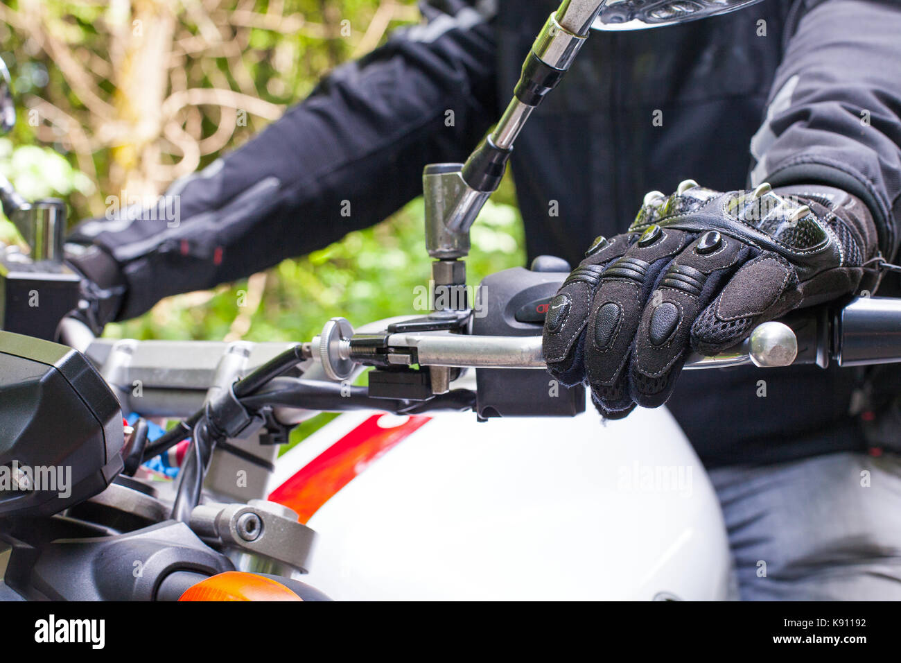 Picture of a motorcycle parked on a country road in a forest Stock ...