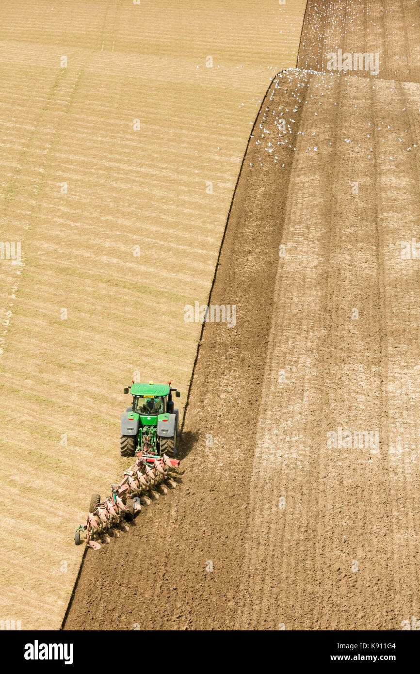 A farmer ploughing chalk hills on the East Yorkshire Wolds Stock Photo