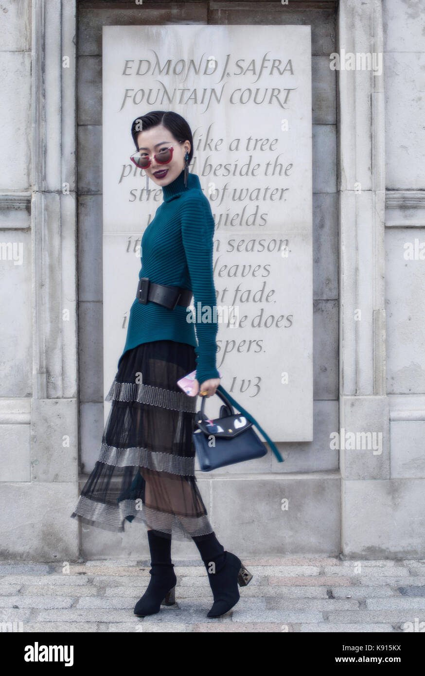 Image shows Harper from China. She wear glasses from Miu Miu, earrings by  Shallow Minx, a Stu Studio top with a belt from Zara, a dress by Carine Wu  with shoes from