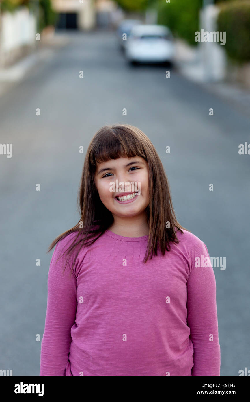 Little preteen girl with pink t-shirt in park Stock Photo - Alamy