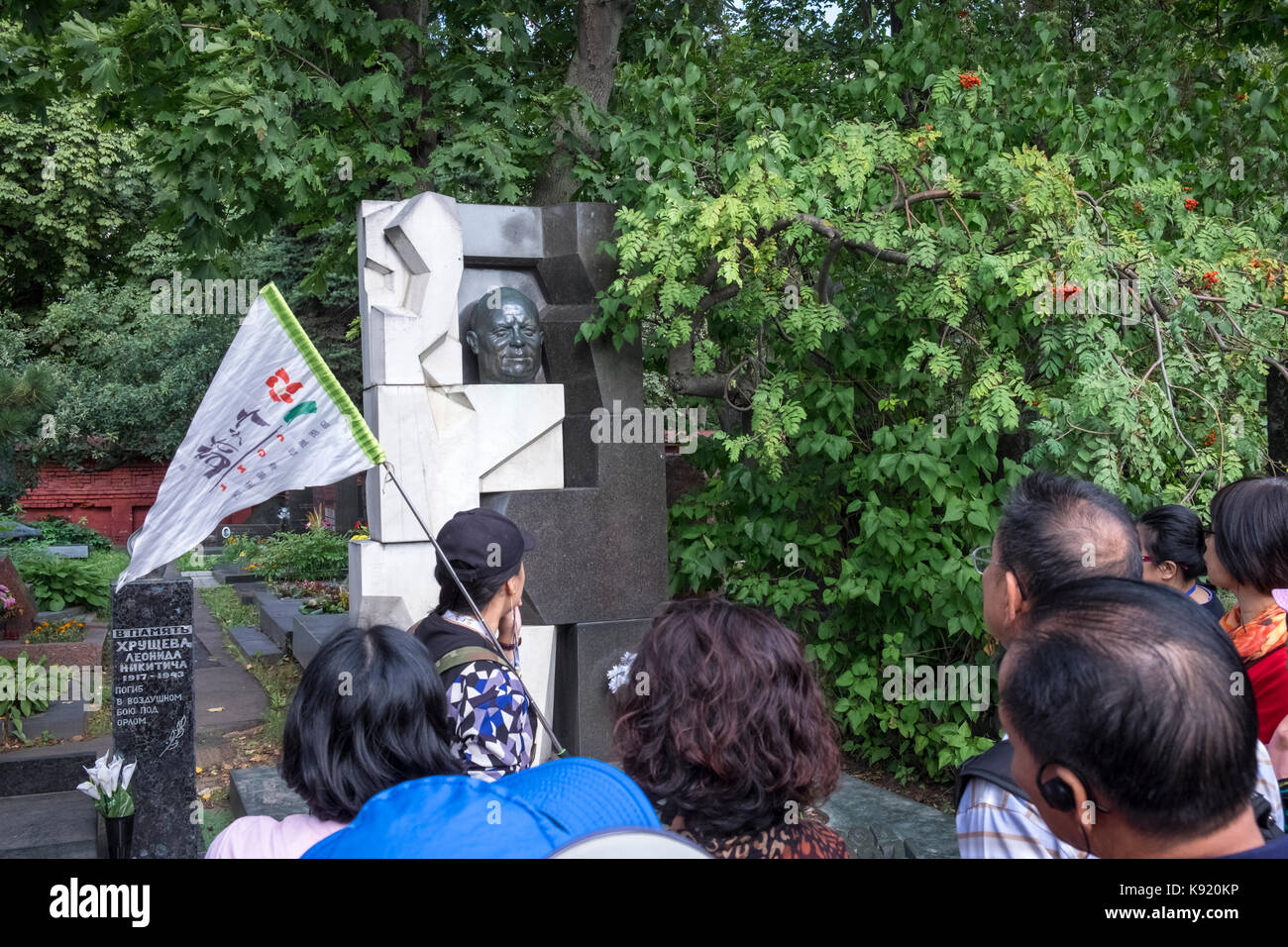 Group of Chinese tourists at the grave of Nikita Krushchev, former leader of the Soviet Union, Novodevichy Cemetery, Moscow, Russia Stock Photo