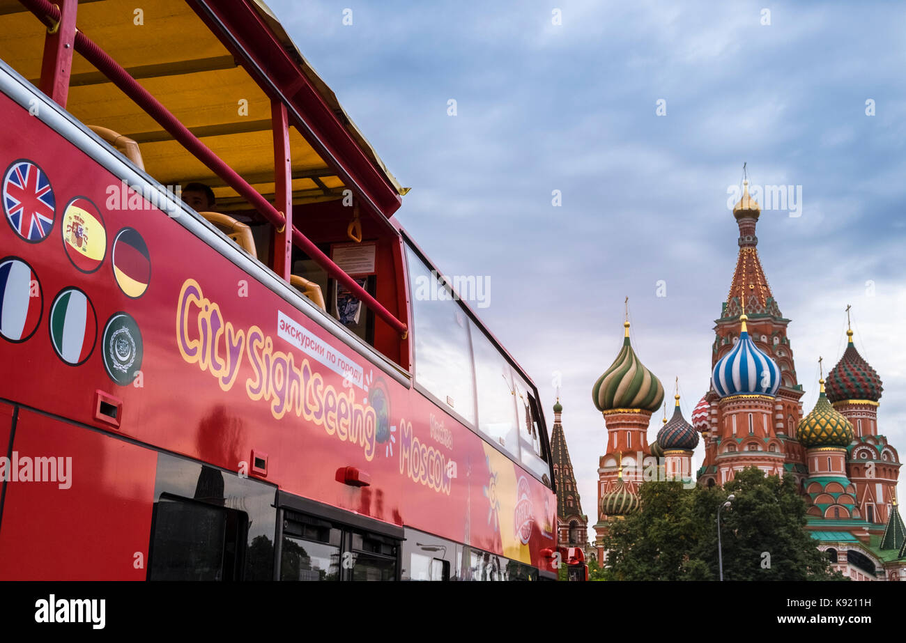 City SIghtseeing open top tour bus in Red Square near St Basil's Cathedral, Moscow, Russia. Stock Photo
