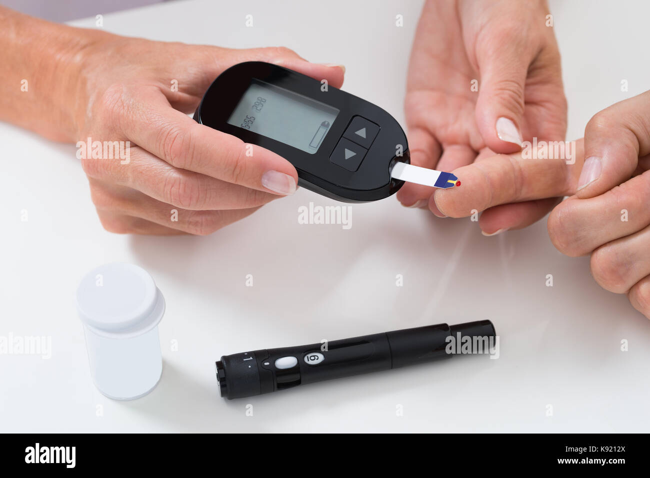 Closeup Of Doctor Measuring Sugar Reading Of Patient With