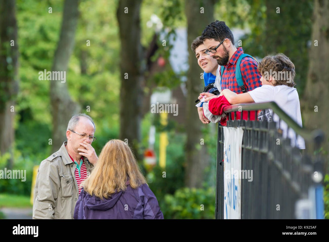 Tourists speaking to strangers and asking directions. Stock Photo