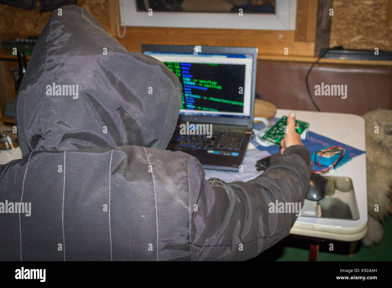 Cyber war, Hacker with laptop initiating hacker attack. Stock Photo