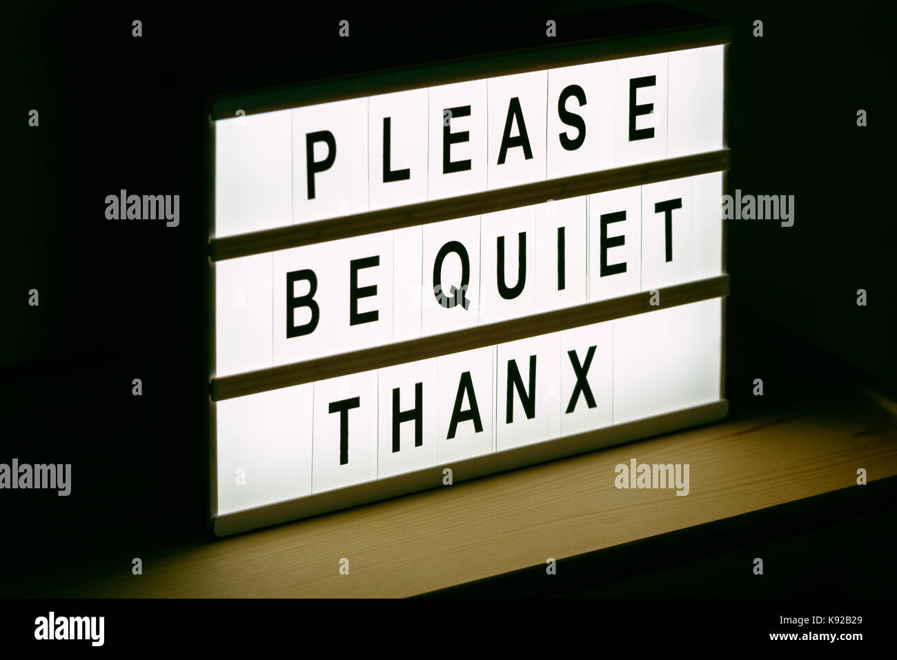 Please be quiet, thanx vintage illuminated message sign in radio or tv studio with live audience Stock Photo