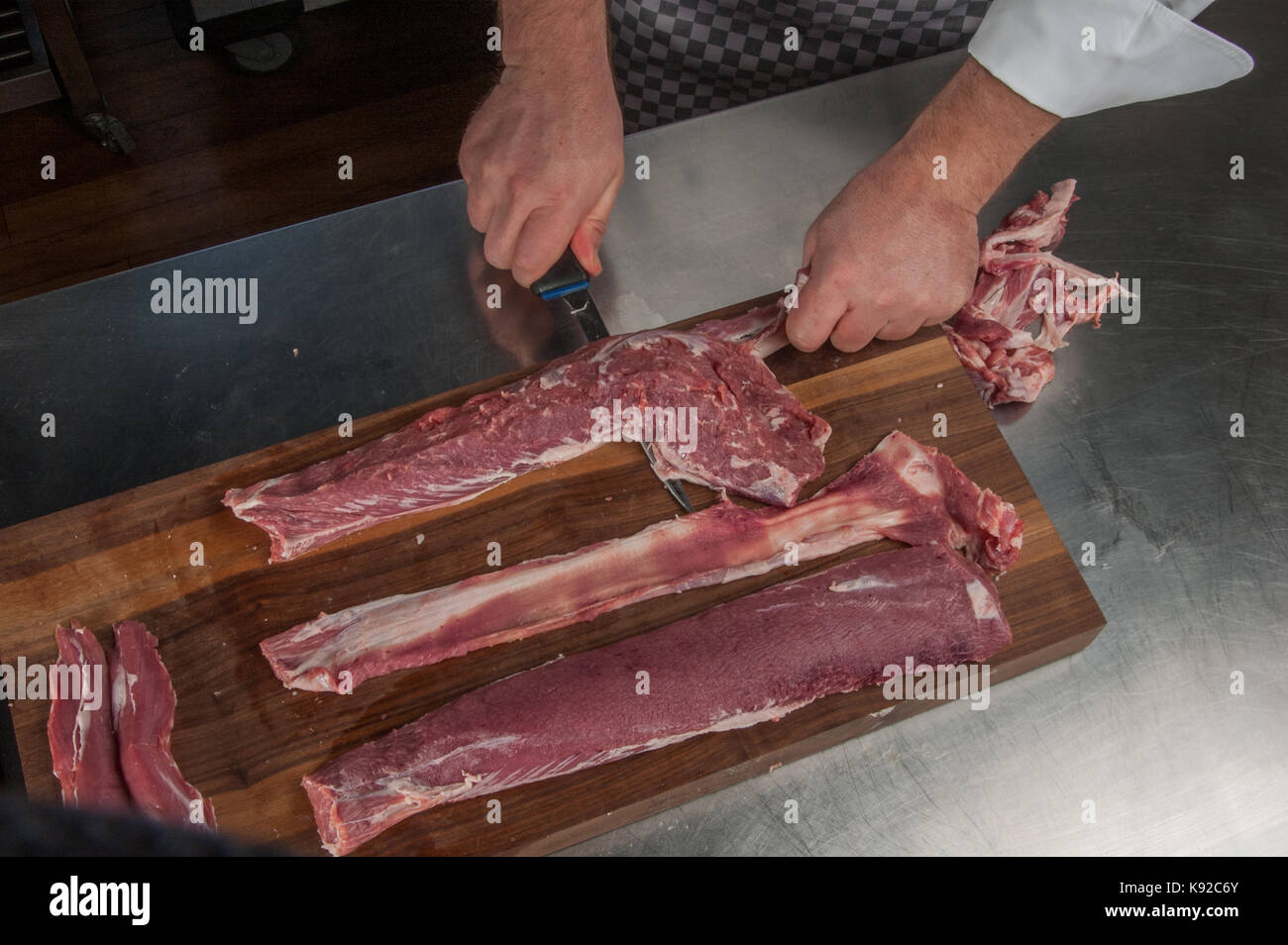 boning a rack of lamb, Restaurant Allegria, Chef Alexander Tschebull, Hamburg, Germany Stock Photo