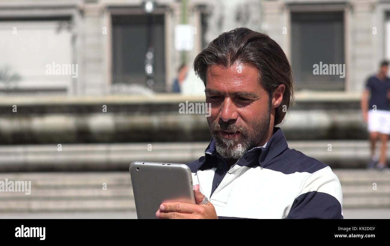 Handsome Spanish Male Using Tablet Stock Photo - Alamy