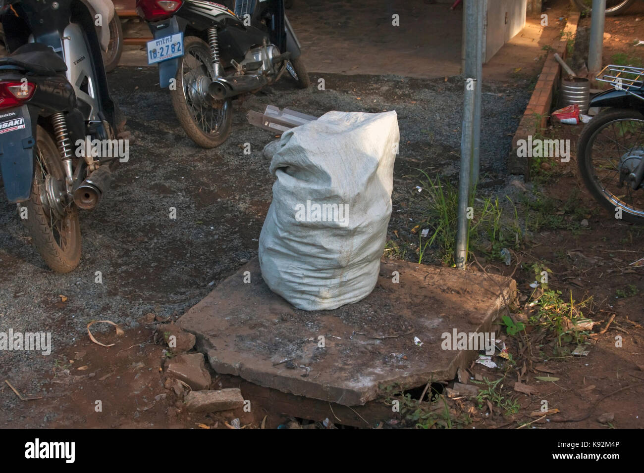 A sack stuffed with marked ballots rests on the ground before the ballots are counted for the 2017 commune elections in Chork Village, Cambodia. Stock Photo