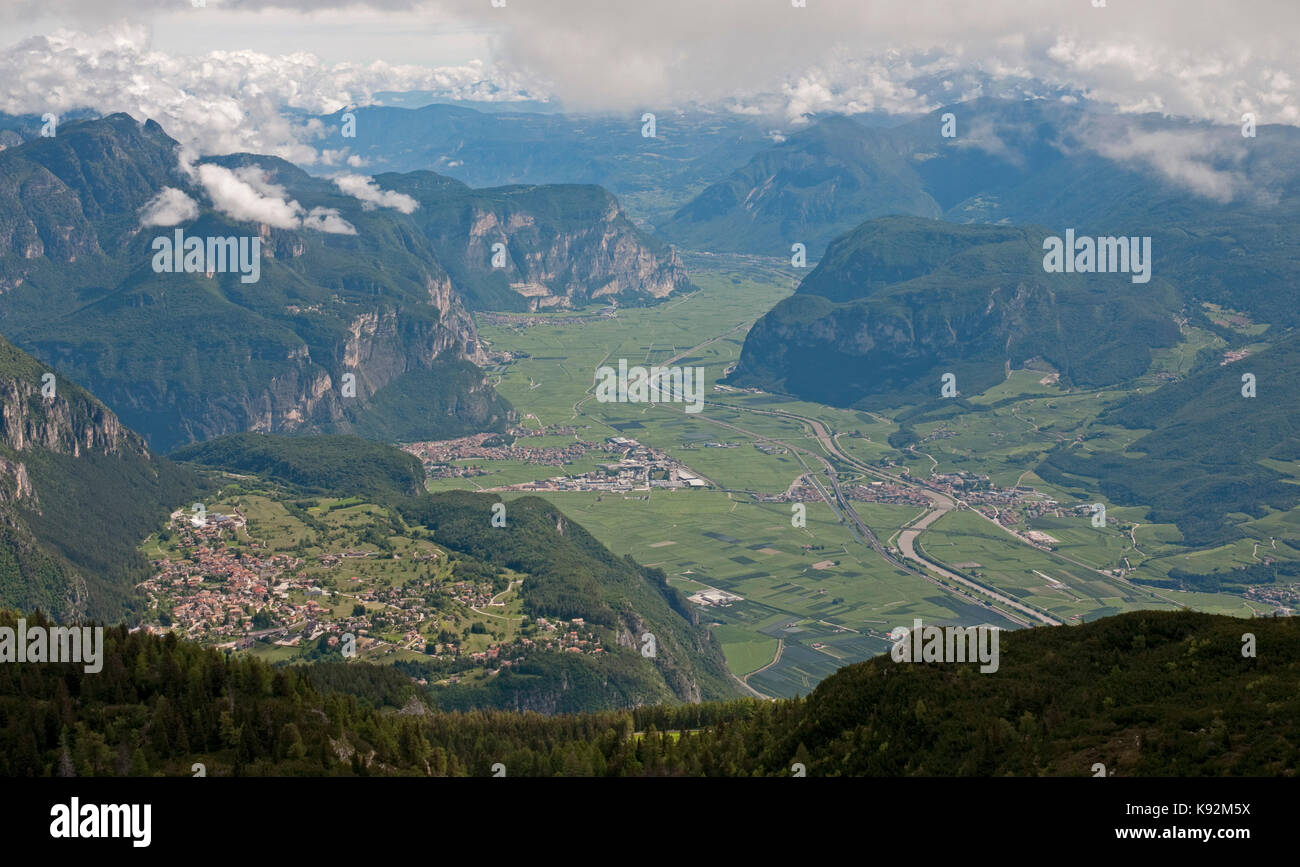 From the peak of La Paganella, looking north along the valley of Adige River, with the village of Fai della Paganella left foreground Stock Photo