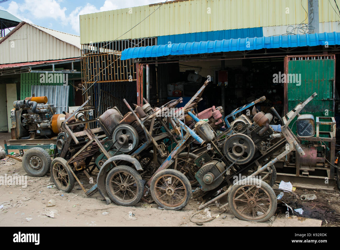 A mechanic garage and workshop, with out of order engines waiting for repairs and maintenance outside. Phnom Penh Cambodia, South East Asia, Indochina Stock Photo