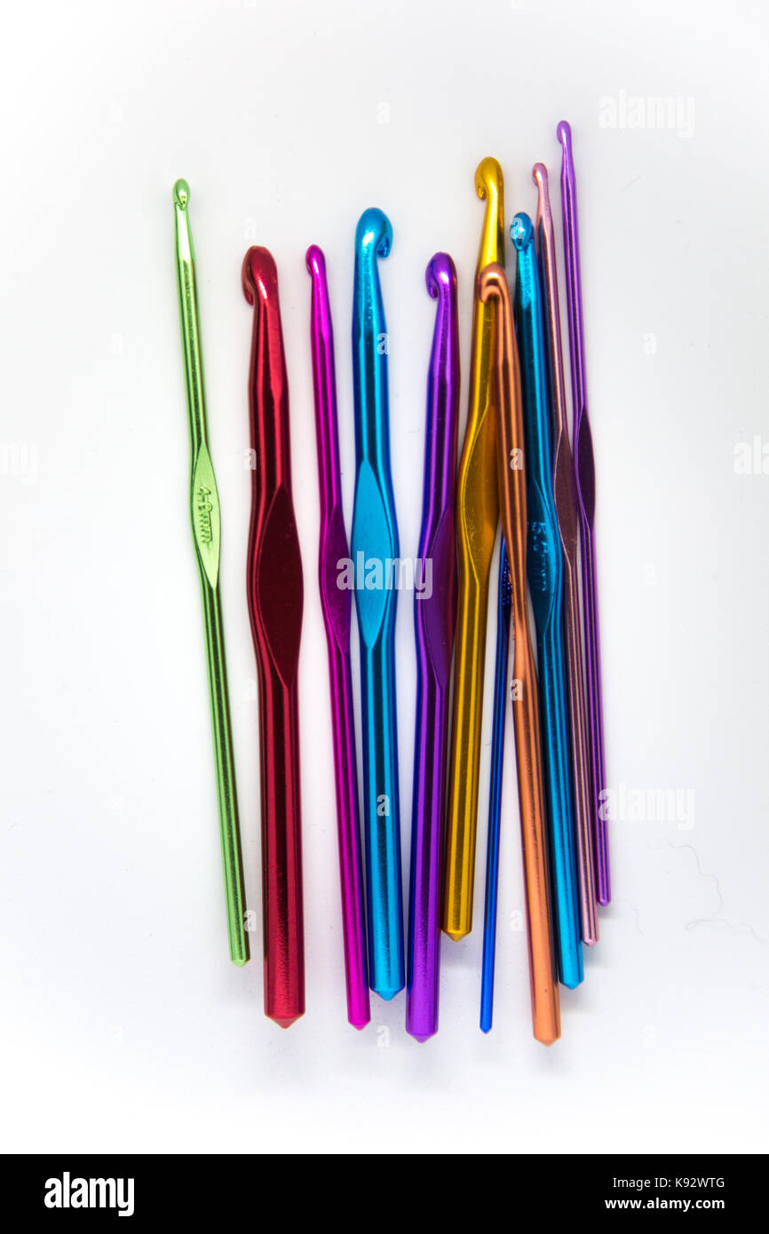 Colorful crochet needles on a white background. A lot of hand craft