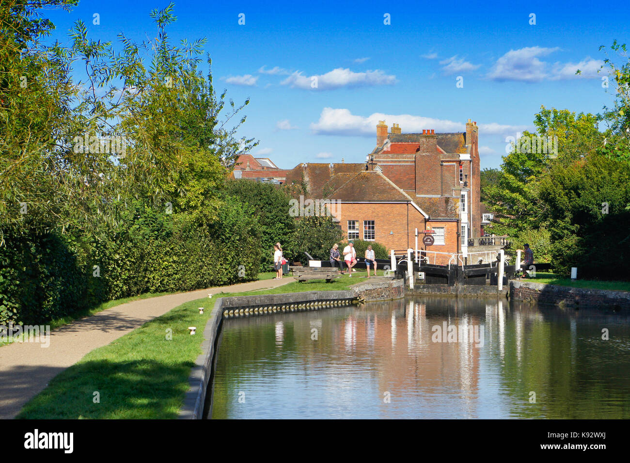 Newbury, UK - August 27 2017:  Peope relaxing by a lock on the canal in Newbury on a summer day Stock Photo