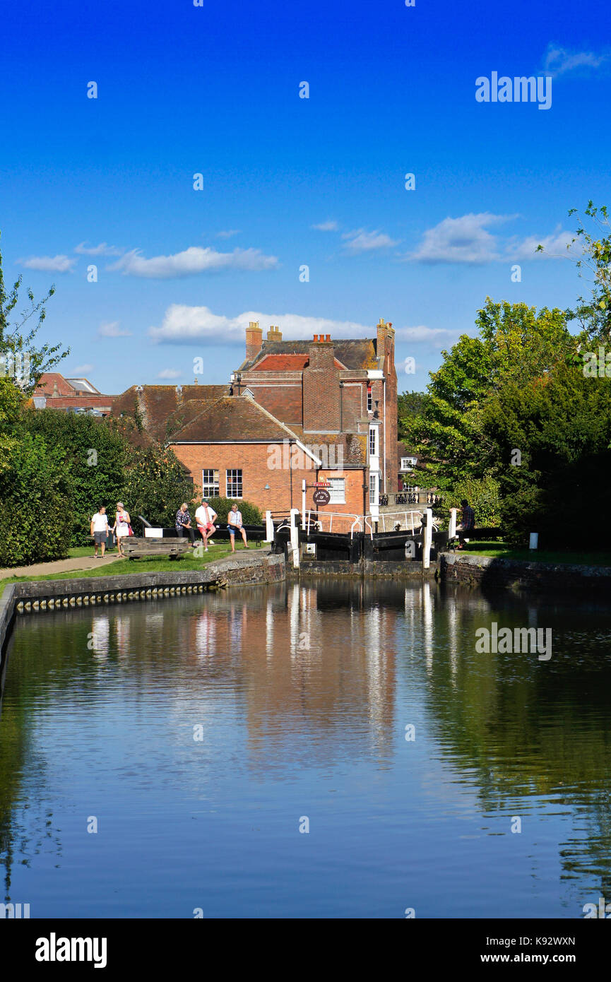 Newbury, UK - August 27 2017:  Peope relaxing by a lock on the canal in Newbury on a summer day Stock Photo