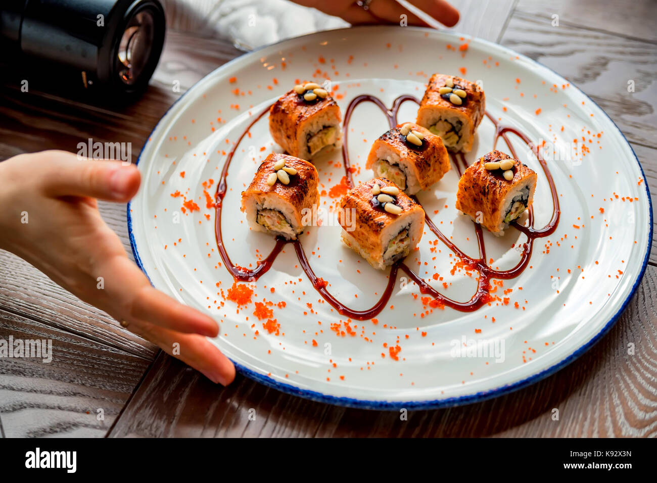 Food photographer takes picure of sushi rolls Stock Photo