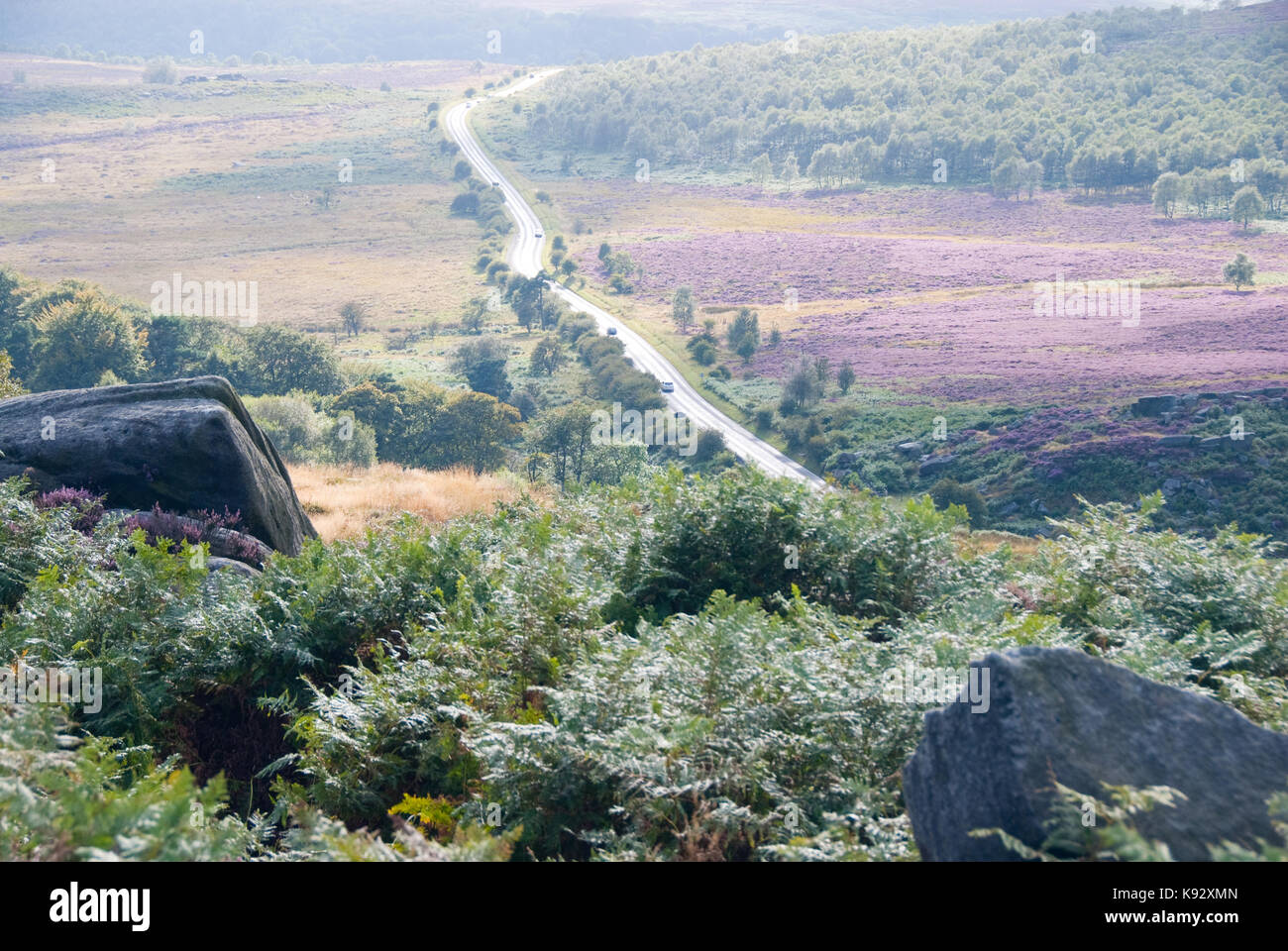 Derbyshire, UK - Aug 2015: Overlooking the Hathersage Road surrounded by pink, green and yellow moorland on 28 Aug in the Peak District Stock Photo