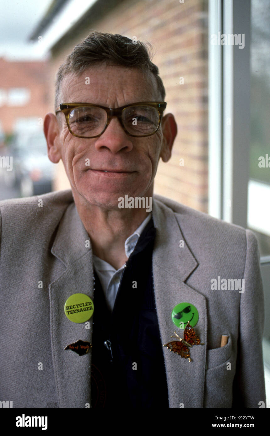 Portrait of an elderly man wearing a button that reads recycled teenager Stock Photo