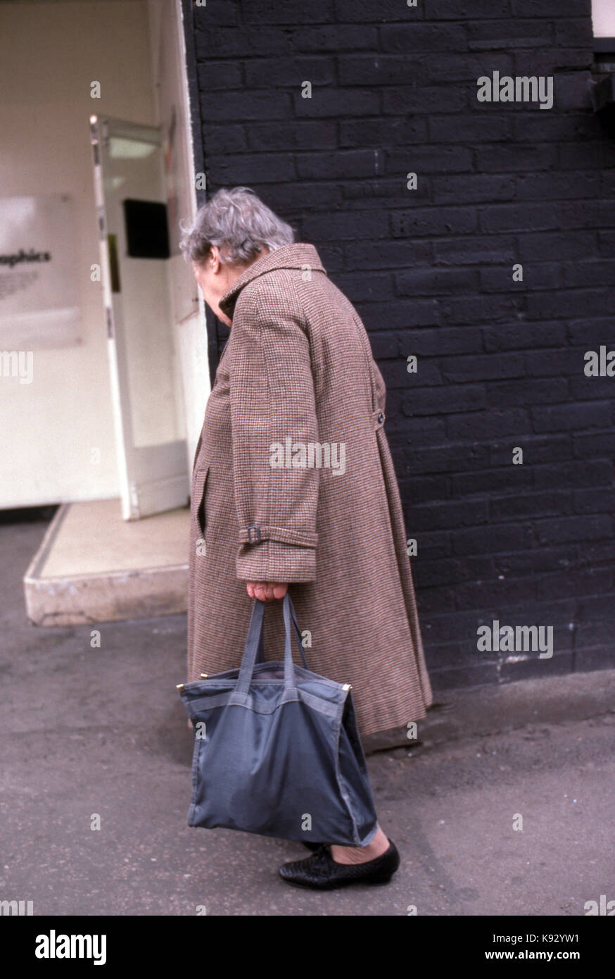 Elderly woman walking alone hi-res stock photography and images - Alamy