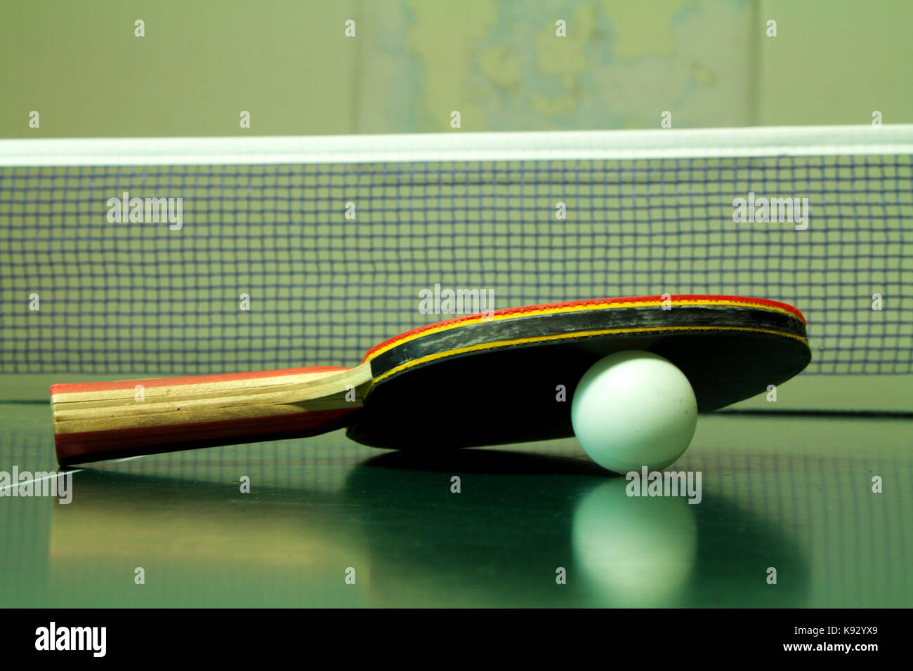 Table tennis racket with white ball on green table Stock Photo Alamy