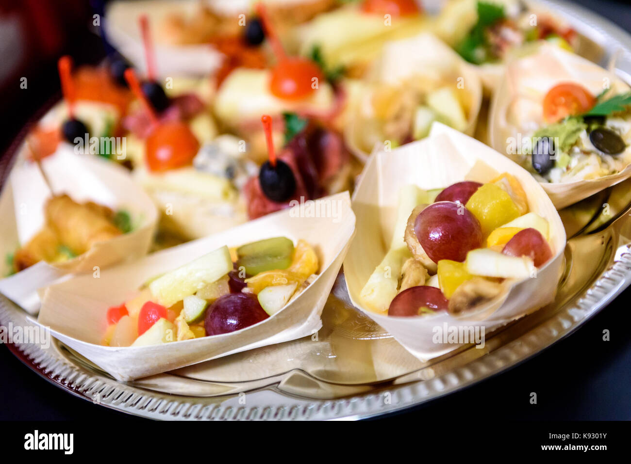 Home made canapes small sandwiches appetizers. Mix of different finger food snacks for a party or banquet on a plate. Stock Photo
