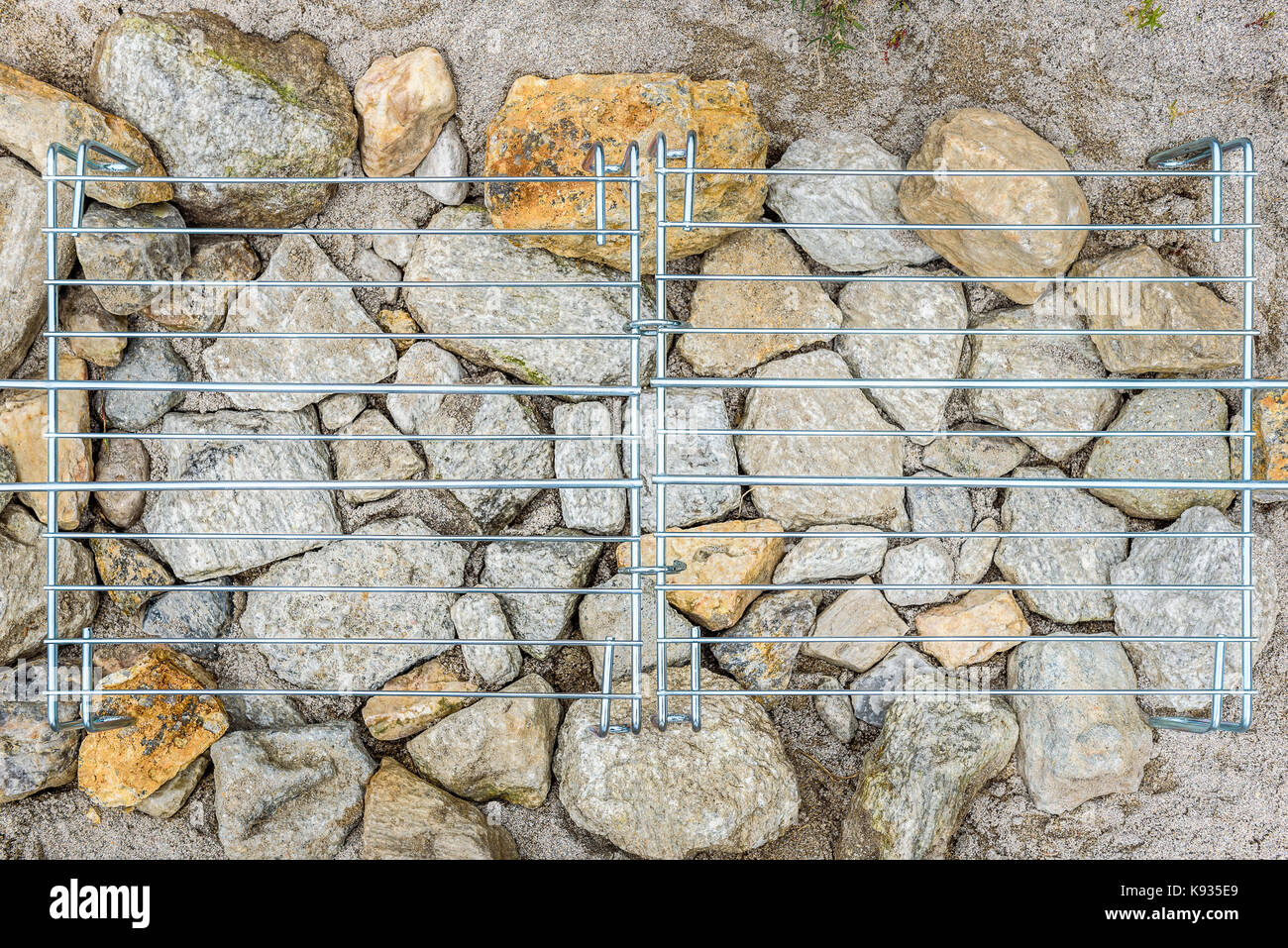 Homemade improvised BBQ barbecue grill on sandy beach on vacation. Making a coal, fire