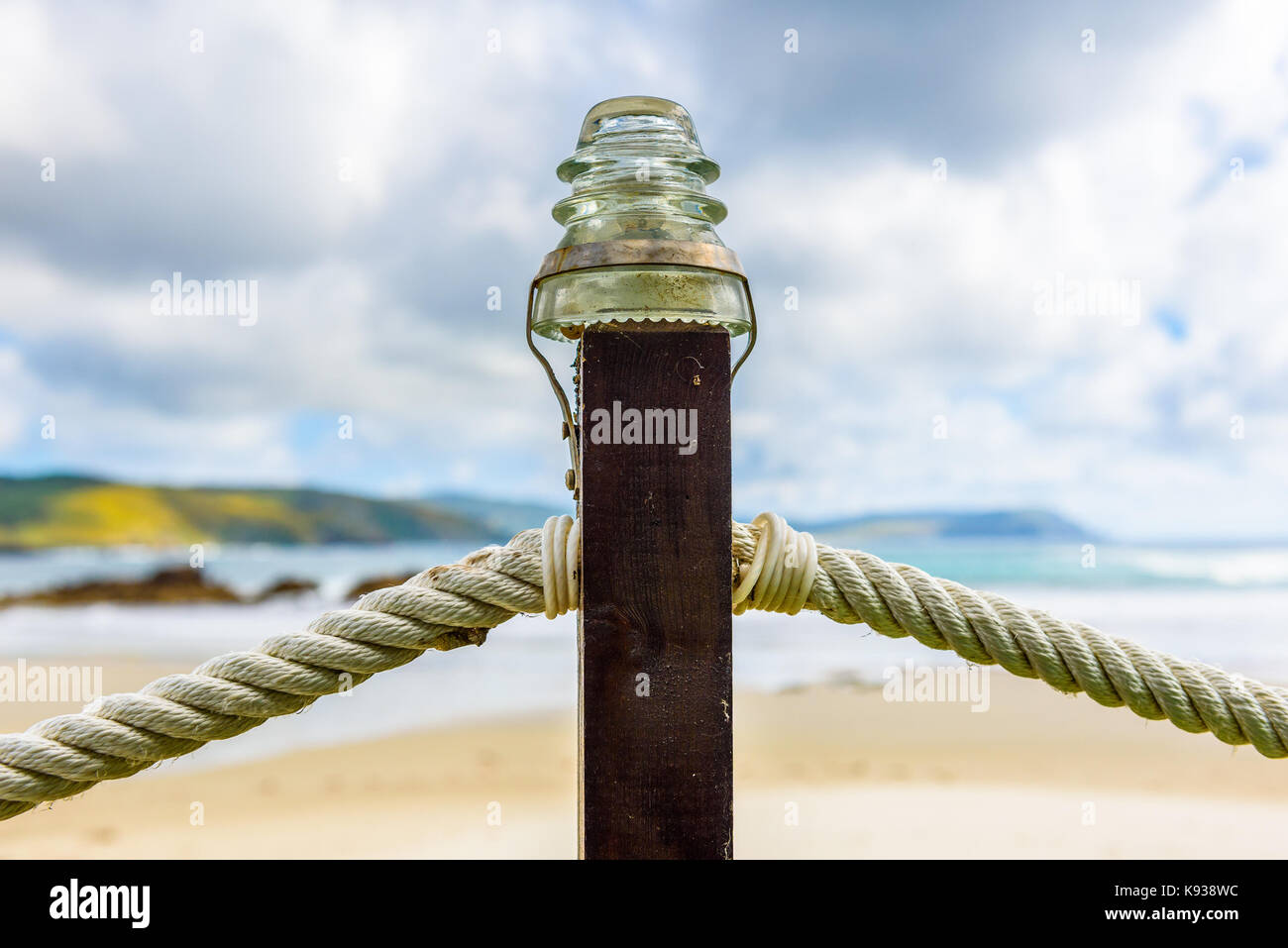 Rope fence on wooden pillar with glass lamp on beach. A wooden fence with  rope inlays on a sandy beach on Atlantic ocean in northern Spain Stock  Photo - Alamy