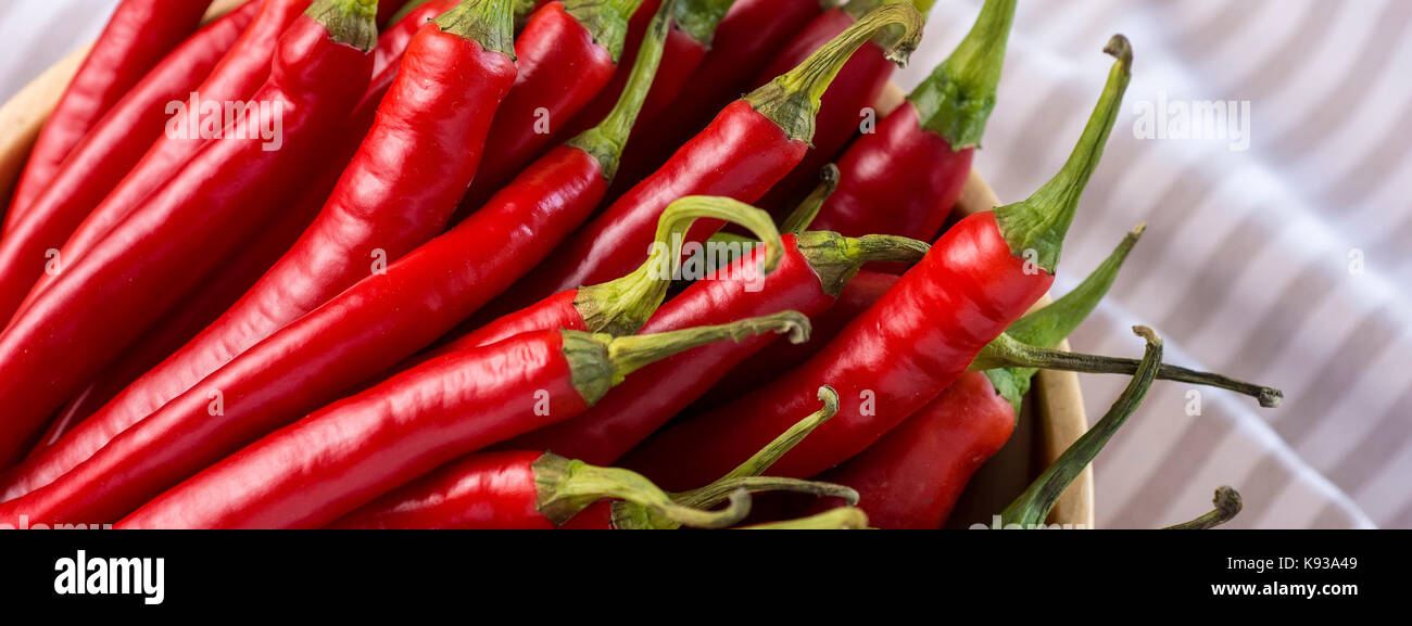 Red Hot Chilli Peppers in Wooden Bowl Stock Photo